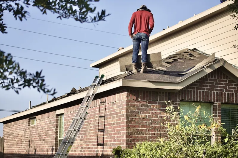 Professional roofer working on a residential roof in Bent Tree